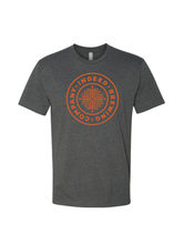 Load image into Gallery viewer, A charcoal Tee with an orange screen printed "Indeed Brewing Company" badge logo on the front.