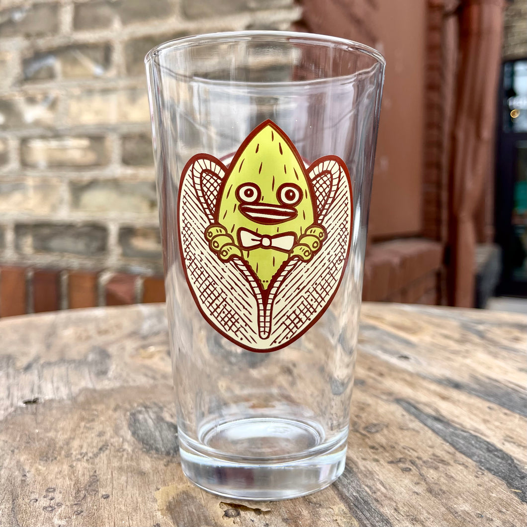An Indeed Pistachio Cream Ale pint glass with an image of an owl on it.