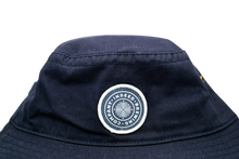 Load image into Gallery viewer, A blue Indeed Bucket Hat with a white Legacy logo on it.
