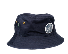 Load image into Gallery viewer, An Indeed Bucket Hat by Legacy with a white patch on it.

